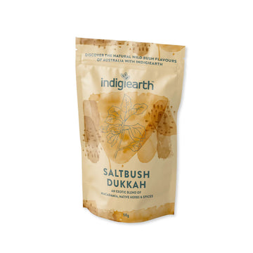 A light orange yellow packet with orange brown overlays. There is a line drawing of a plant in blue in the centre and the text 'Indigiearth Saltbush Dukkah' written in blue.