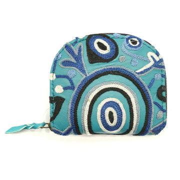 A blue coin purse embroidered with a design by Theo Hudson.