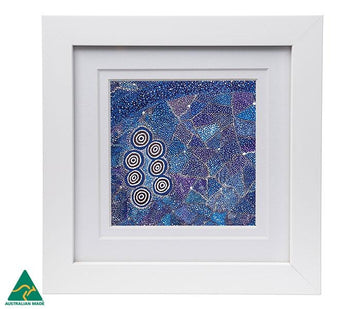 A square picture featuring artwork by Alma Granites in a blue and white dot design inside a inset white frame.