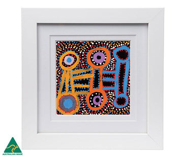 Colourful print 10cm x 10cm of a painting by Warlukurlangu artist Watson Robertson. Australian Made, presented in a white frame 18.4cm x 18.4cm behind perspex glass. Freestanding can be hung.