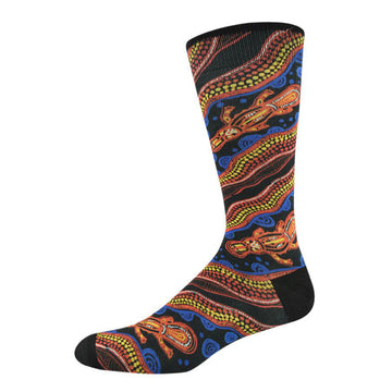 Side view of bamboo blend sock featuring indigenous artwork by Nathan Patterson. Top view of platypus swimming on blue circles. Orange, yellow, indigenous motif. Black toe and heal.