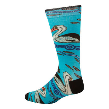 Side view of bamboo blend sock featuring indigenous artwork by Nathan Patterson. Side view of pelican swimming among fish, blue water, and circles. Turquoise with black heal and toe.