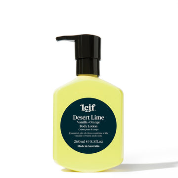 A yellow bottle with a black pump lid and a teal green circle in the middle. The circle contains product information in white.