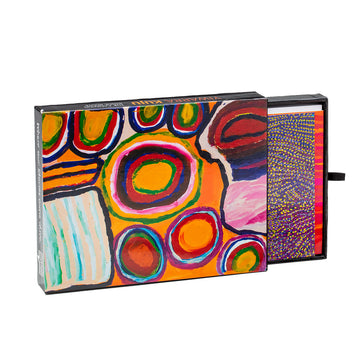 Card pack, gift boxed, containing twelve blank cards and envelopes. Brightly coloured circles and shapes on box with orange background. Box is open with an assortment of cards displayed.