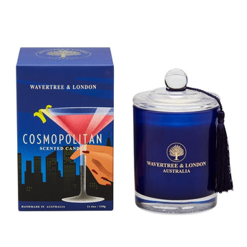Candle by Wavertree and London. Cosmopolitan. Dark blue glass vessel with lid packaged in a blue box with a picture of a cocktail on the front.