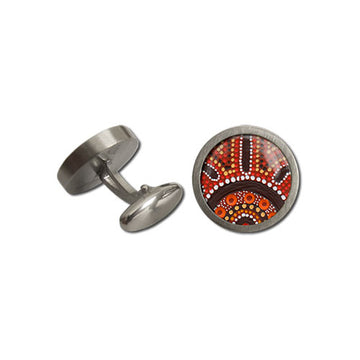Brushed, round, stainless-steel cufflinks in front and rear view. Features artwork by Kathleen Buzzacott with red background; brown brush strokes; yellow, orange, and white dot art. Made in Australia.