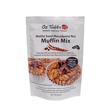 A white packet of muffin mix featuring product information on the packet and a photo of three muffins.
