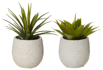 Two artificial plants inside white concrete look pots with a round shape.