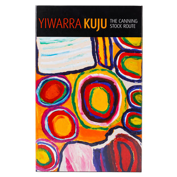 Angle view of box cover of 'Yiwarra Kuju' 1000 piece puzzle featuring artwork of circles in yellow, red and blue.
