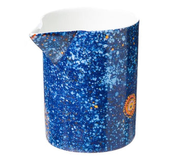 Made in Australia fine bone china milk jug/creamer presented in a gift box. Vibrant blue with orange circle and dots painted by Alma Granites. Glossy white inside 8.5cm high.