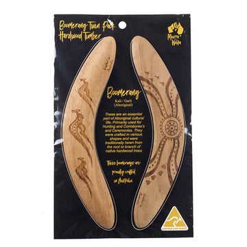 Two boomerangs are pictured in packaging. One boomerange features carvings of three kangaroos and the other features carvings of circles and tracks.