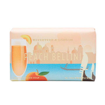 A bar of soap is wrapped up in paper packaging with an illustration of a peach drink in front of water and a city skyline in the back.
