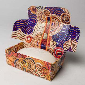 A soap box pictured with artwork by Nora Nyutjangka Davidson in blue and yellows.