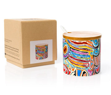 Fine bone china cylindrical sugar bowl and white ceramic spoon with wooden lid. Colourful artwork by Judy Watson, in blue, yellow, pink, orange, black. Made in Australia cardboard gift box.