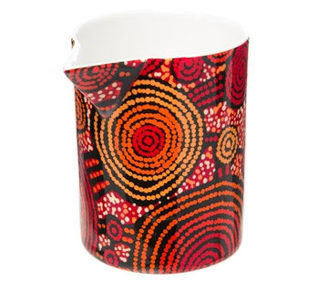 Milk jug featuring artwork by Teddy Gibson in red, orange and yellow circles.