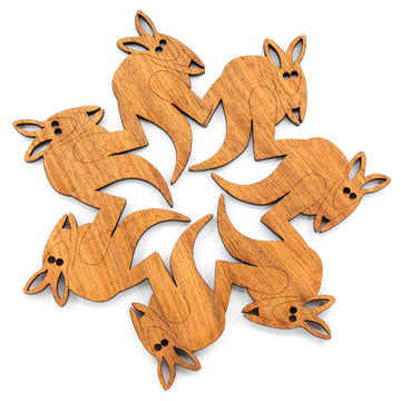 A wooden trivet made from seven kangaroos cut out with their foot touching the kangaroo in front's back to make one piece.