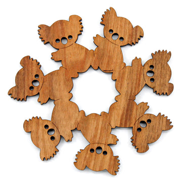 A wooden trivet featuring koalas cut out and touching to form one shape.